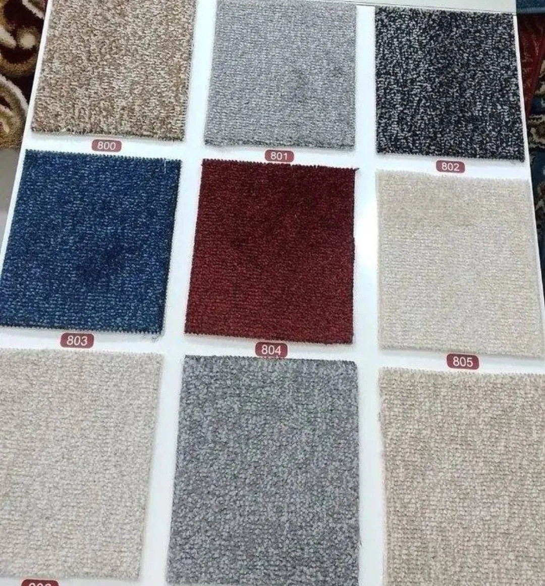 Riwaq tweed office carpet swatch board in beige, grey, black tweed, blue and burgundy